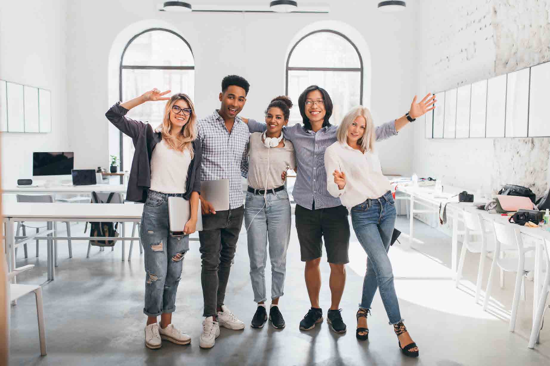 full length portrait slim female office worker jeans standing with legs crossed near asian colleague indoor photo tall african student glad european woman with laptop.pdf